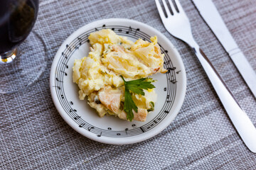 Appetizing Spanish salad is Ensalada alemana, made from potatoes, sausage, cucumbers, seasoned with...