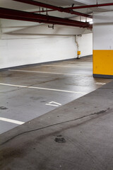 Empty underground parkade with footprint; underground car park with view of parking stalls