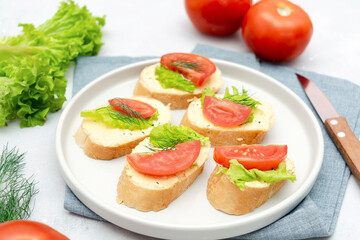 Bruschetta sandwich bread toast with soft white cheese ricotta,fresh tomatoes,basil greenery on cutting board. Tasty healthy vegetarian food,Italian cuisine appetizer. top view flat lay
