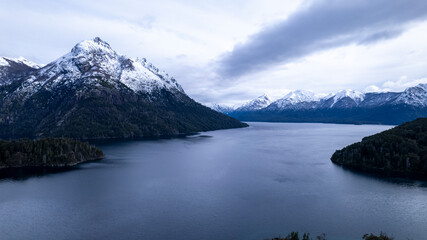 Beautiful chain of snowy mountains and a lake with blue sky above in Bariloche Argentina, amazing panoramic view at Circuito Chico Patagonia