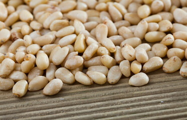 Pine nuts on a wooden surface. Natural background