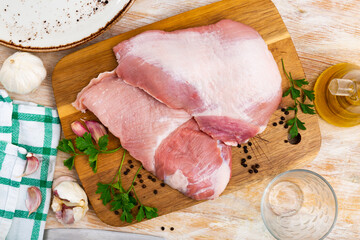 Fresh raw pork secreto fillet, special cut of Iberian pig meat and condiments prepared for roasting...