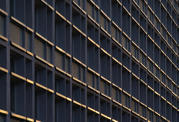 the facade of the building with window recesses and window sills glistening in the sun
