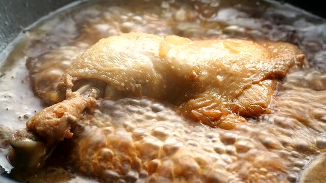 Stewing chicken in vinegar and soy sauce or Chicken Adobo. Filipino famous food.