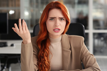 Emotional woman having video call in office, view from web camera