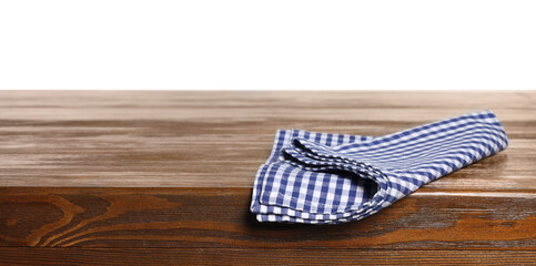 Checkered tablecloth on wooden table against white background
