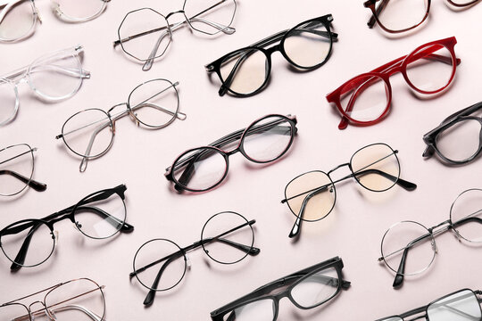Many different stylish glasses on light grey background, flat lay