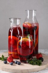 Delicious refreshing sangria and berries on table