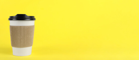 To-go drink. Paper coffee cup on yellow background, space for text. Banner design