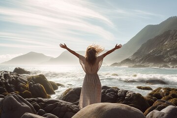 A young woman with outstretched arms enjoying the wind and breathing fresh air on the rocky beach , sunset , Generative AI. - obrazy, fototapety, plakaty