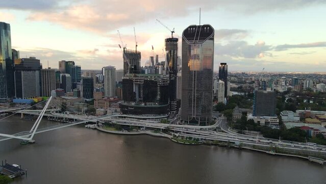 Aerial drone view of Brisbane City, QLD, Australia showing the west facing side of the city along Brisbane River and Riverside Expressway and Neville Bonner Bridge during late afternoon in August 2023