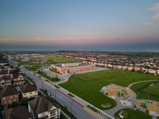 Fototapeta na wymiar Experience the magic of Vaughan sunrise through mesmerizing drone photos. Witness the enchanting amusement park, thrilling roller coasters, and vibrant Vaughan schools