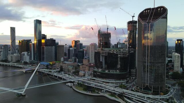 Aerial drone view of Brisbane City, QLD, Australia showing the west facing side of the city along Brisbane River and Riverside Expressway and Neville Bonner Bridge during late afternoon in August 2023