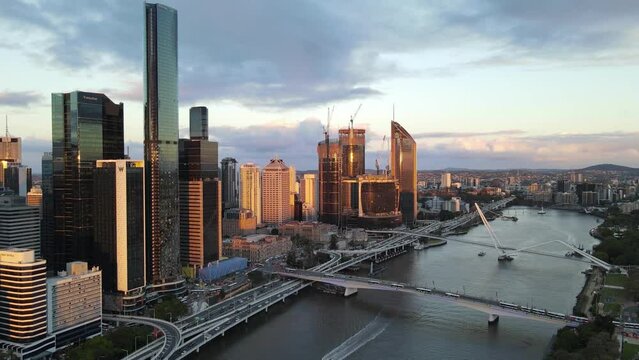 Aerial drone view of Brisbane City, QLD, Australia of the west facing side of the city along Brisbane River and Riverside Expressway looking toward South Brisbane during late afternoon in August 2023 