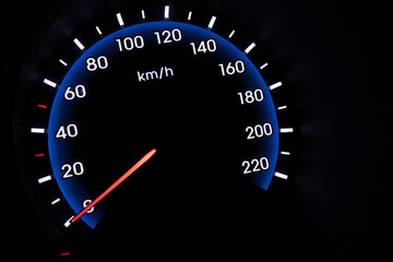 Car speedometer on black background showing 0 KM per hour