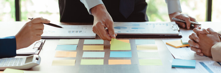 Group of business colleague read data in sticky notes to brainstorming and coworking new business