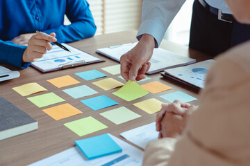 Group of business colleague read data in sticky notes to brainstorming and coworking new business