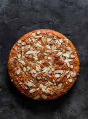 Oatmeal, chocolate, greek yogurt cake on a dark background, top view