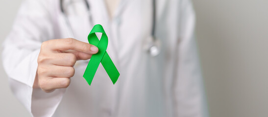Doctor with green Ribbon for world Mental Health Day, Liver, Gallbladders, bile duct, cervical,...