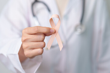 Peach Ribbon for September Uterine Cancer Awareness month. Healthcare and World cancer day concept