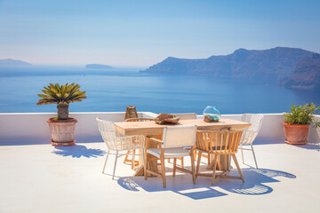 Santorini for relaxation. Greece, Santorini island, Oia - white architecture and deep blue. Table and chairs on the terrace. Greek Islands, Santorini