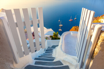 Amazing Gate to heaven. Santorini, Greece. White architecture, open doors and steps to the blue sea of Santorini.