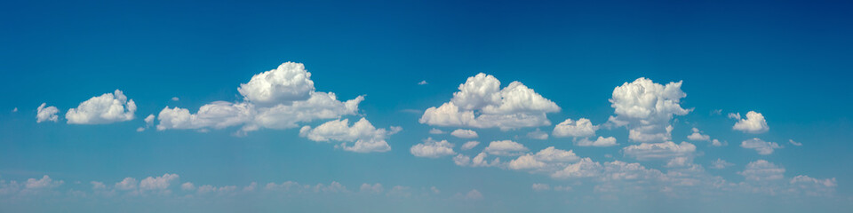 Panoramic sky - real blue sky during daytime with white light clouds Freedom and peace. Large photo format Cloudscape blue sky.