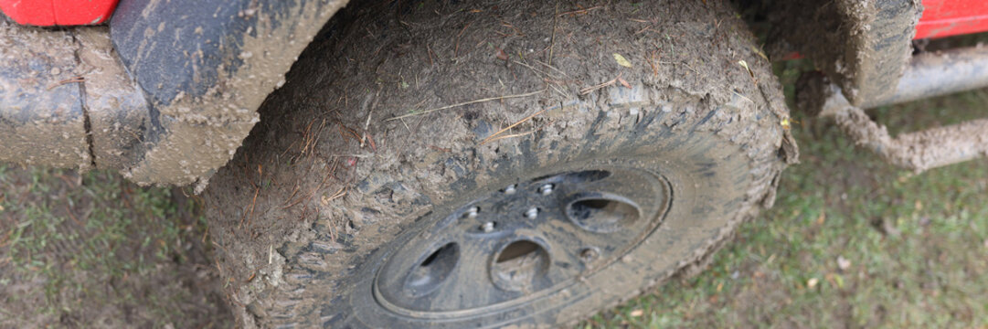 Close up of offroad car dirty wheel.