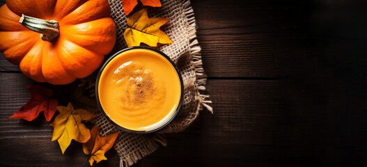 In line with the Halloween concept, an autumnal banner presents a glass of aromatic pumpkin beverage.