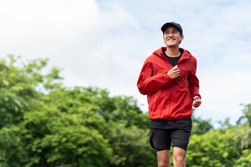 Attractive Young indian man wearing sportswear running on track at sport stadium. Asian Fit man...