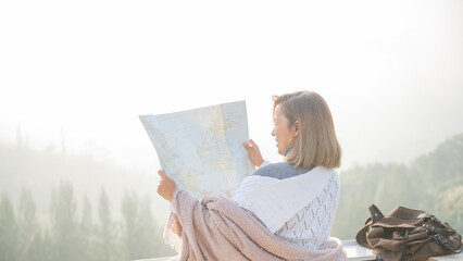 Girl tourist in mountain read the map and looking mountain view at countryside homestay in the...