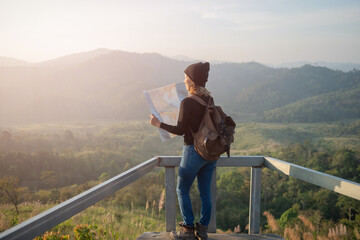 Adventurous girl navigating in with a topographic map in beautiful mountains of thailand. woman...