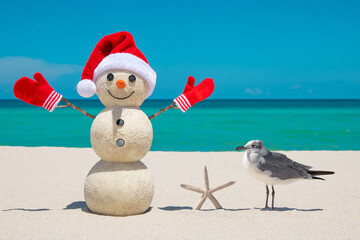 Snowman. Sandy Snowman on the beach. Christmas snowman with red Santa Claus hat and mittens. Smiley Snow man. Miami Beach Florida. Winter Holidays. Celebration Happy New Year. Xmas postcards. Travels