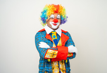 Mr Clown. Portrait of Funny face Clown man in colorful uniform standing arms crossed smiling to...
