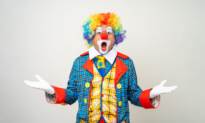 Mr Clown. Portrait of Funny shocked face comedian Clown man in colorful costume wearing wig...