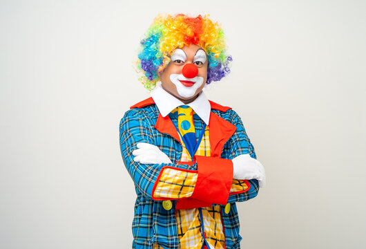 Mr Clown. Portrait of Funny face Clown man in colorful uniform standing arms crossed smiling to camera. Happy expression male bozo in various pose on isolated background.