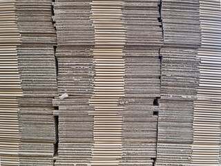 Stack of folded sending boxes in a warehouse. Cardboard texture background