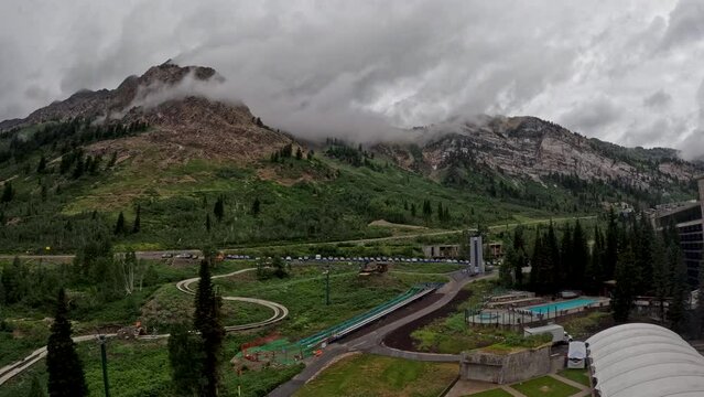 Timelapse mountain resort rides clouds vehicles people Utah. Summer and winter all season mountain resort. Vacation nature family fun destination. Recreation on rides, activities and events.