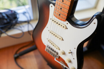 Electric guitar and strings. The guitar's electrifying sound represents creative energy, passion,...