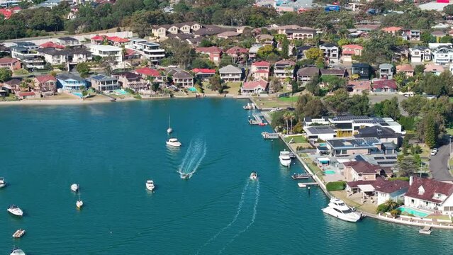 4K Drone aerial point of view over watsons bay in east Sydney, NSW, Australia with boat yacht floating in turquoise water in sunny day. Landmark famous place and water transportation concept.