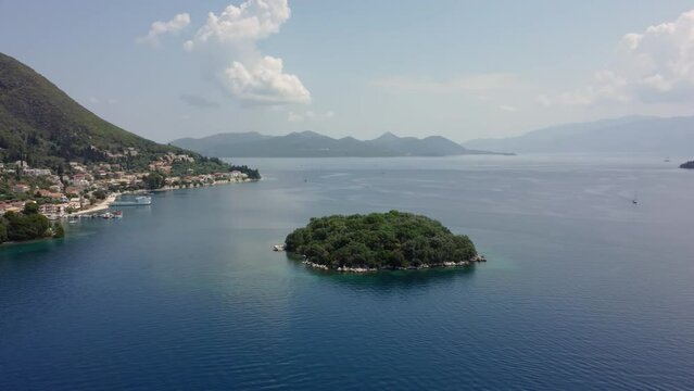Cinematic aerial drone footage with smooth rotation motion over Nydri, Lefkada, Greece during the summer season