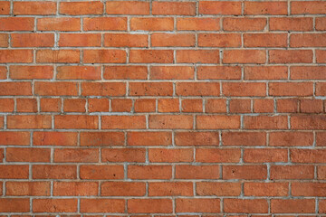 Obraz premium Red brick wall background in rural room. Abstract weathered texture stained old stucco light Red. Red grunge brick wall background.