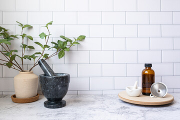 Homeopathy or herb medicine concept. Aromatherapy bottle with funnel and pestle and mortar.