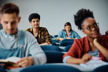 Young Muslim student paying attention during lecture in classroom.