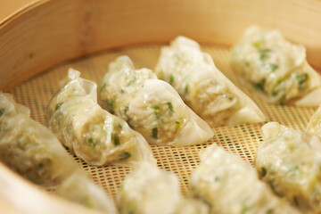 Meat dumplings in wooden steamer