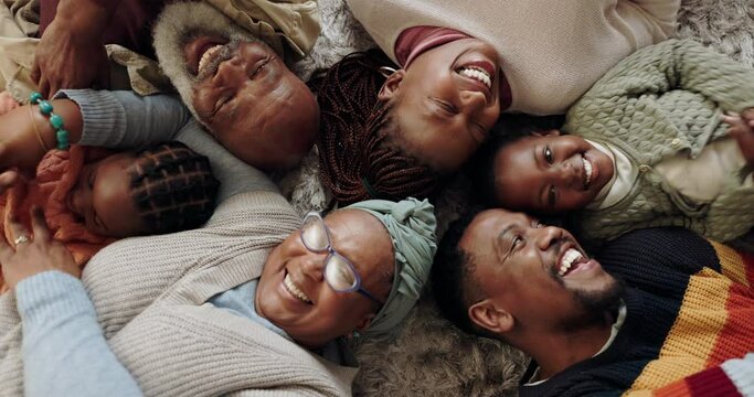 Top view of grandparents, parents and children on floor for bonding, having fun and relax together at home. Black family, grandma and grandpa with happy kids cuddle with mom and dad in living room