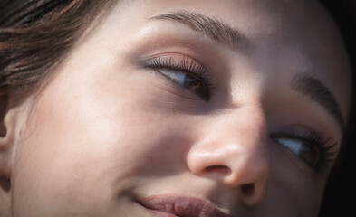 Close up of a beautiful woman's face with brown eyes and long eyelashes