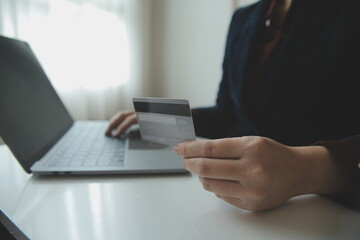 Woman hands holding and using cradit card for shopping online.