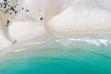 aerial top view of the shore of a turquoise water beach