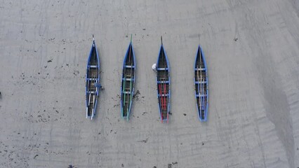 Top down bird's eye view descending drone shot above currach irish canoe boats